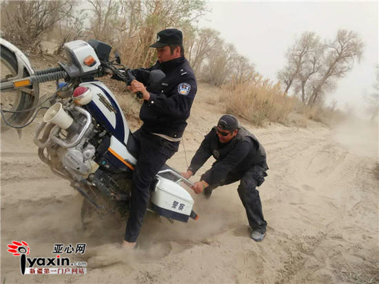 Braving dust and wind, policemen in the desert ride motorcycles to perform duty