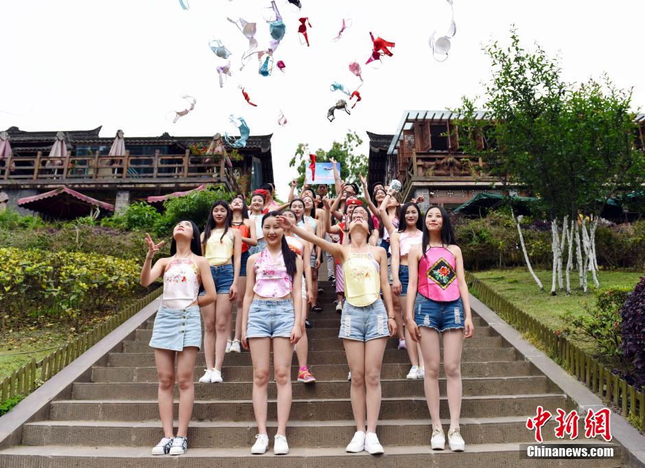 University students throw bras in the air to call for awareness of breast health
