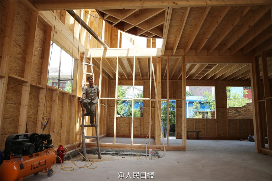 Father builds wooden house for his son as a wedding gift