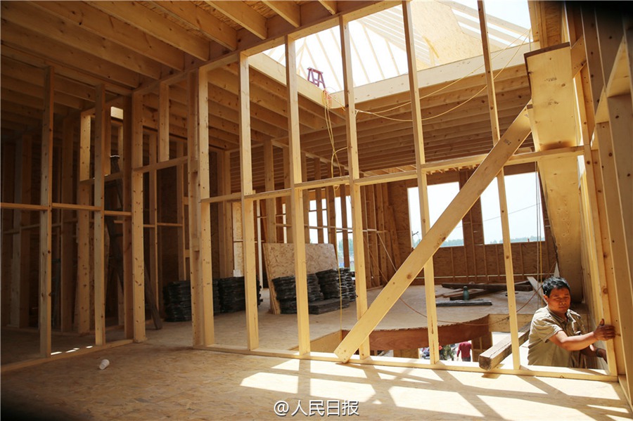 Father builds wooden house for his son as a wedding gift