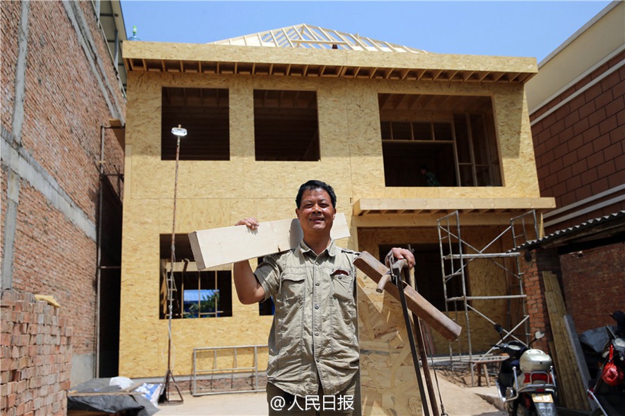 Father builds wooden house for his son as a wedding gift