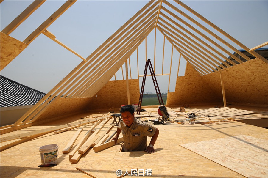 Father builds wooden house for his son as a wedding gift