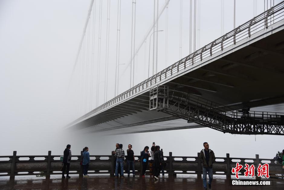 Asia's longest suspension bridge 'disappears' in fog