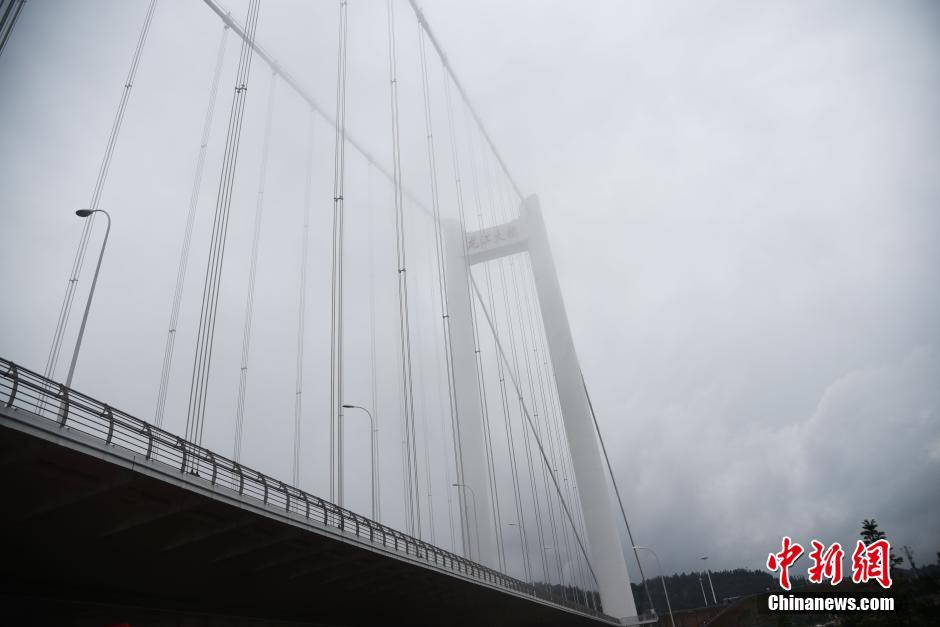 Asia's longest suspension bridge 'disappears' in fog