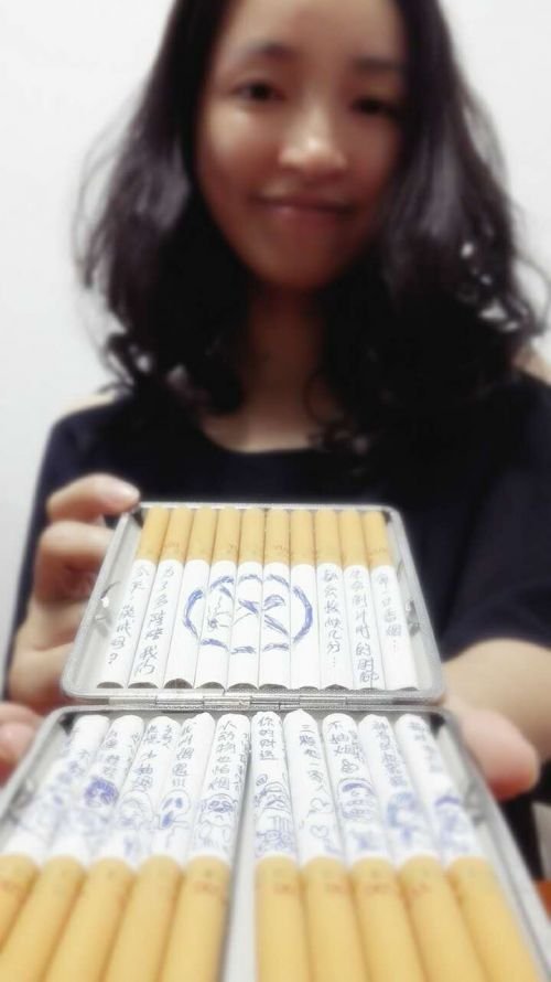 Wife draws cartoons on cigarettes to suggest to her husband that he should quit smoking