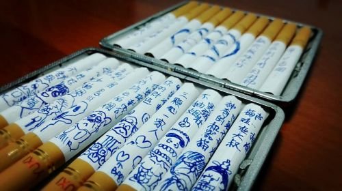 Wife draws cartoons on cigarettes to suggest to her husband that he should quit smoking