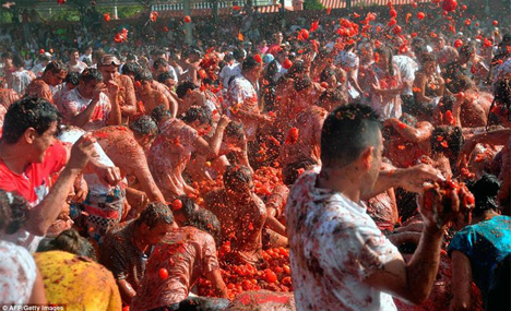 Thousands throw tonnes of tomatoes at each other