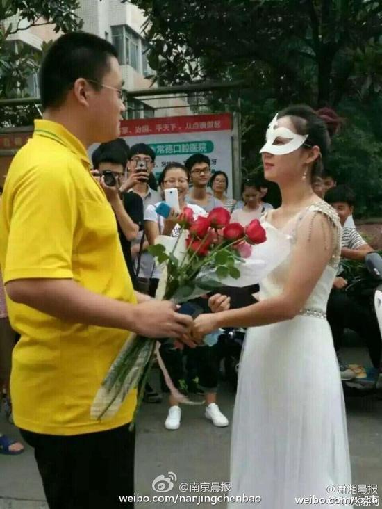 Female college teacher proposes to student in wedding dress