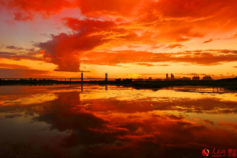 Fiery sunset glows over Songhua River