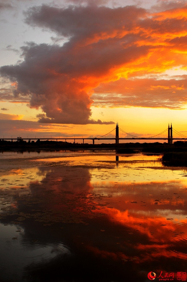 Fiery sunset glows over Songhua River