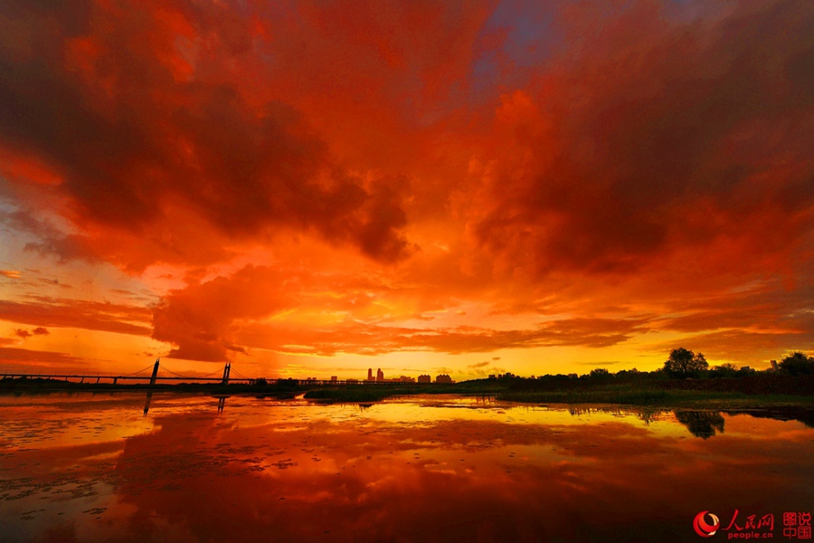 Fiery sunset glows over Songhua River