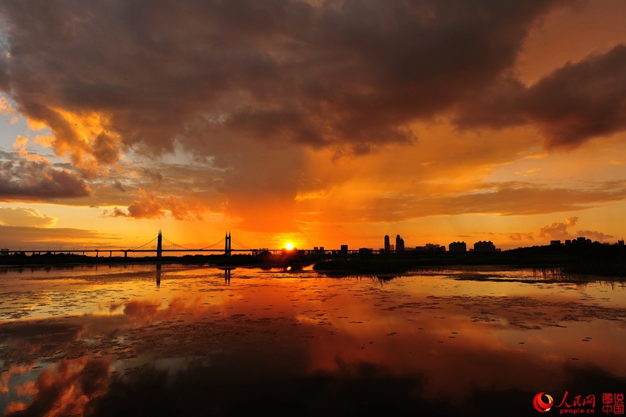 Fiery sunset glows over Songhua River