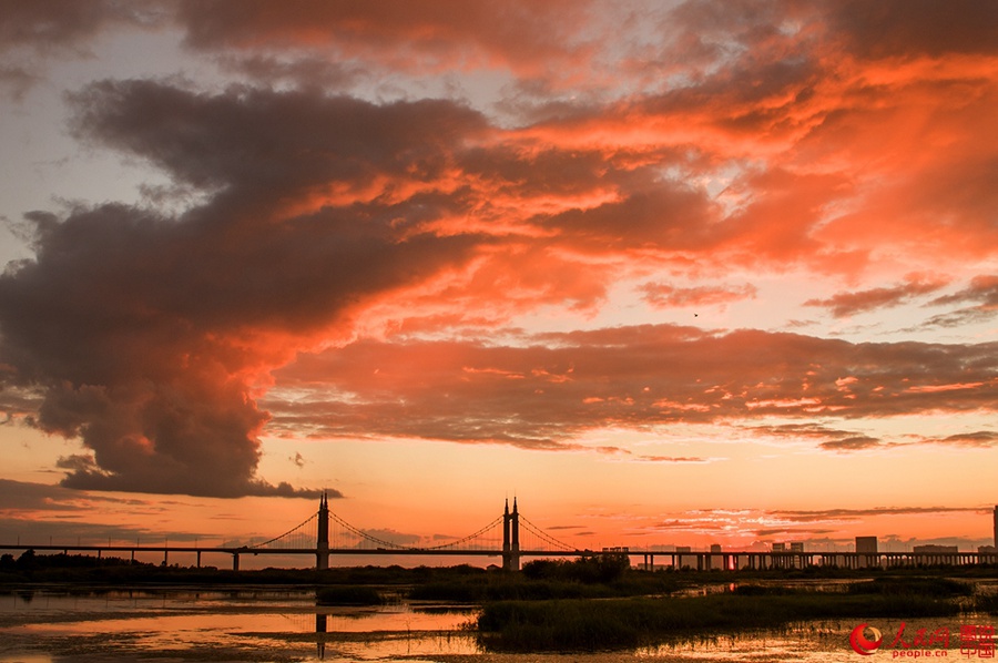 Fiery sunset glows over Songhua River