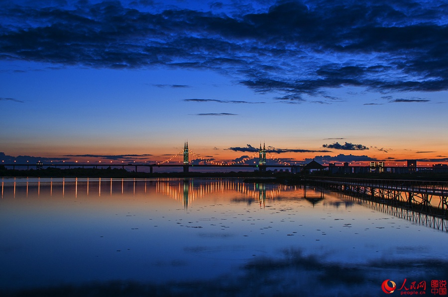 Fiery sunset glows over Songhua River