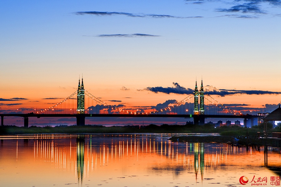 Fiery sunset glows over Songhua River