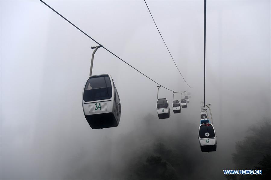 Tourists visit Laojieling scenic spot amid fog in Xixia County