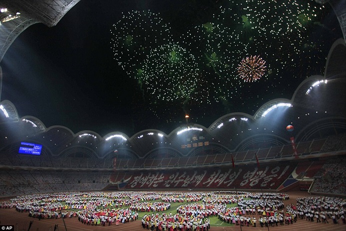 Thousands of torch-carrying youths celebrate in Pyongyang's May Day Stadium