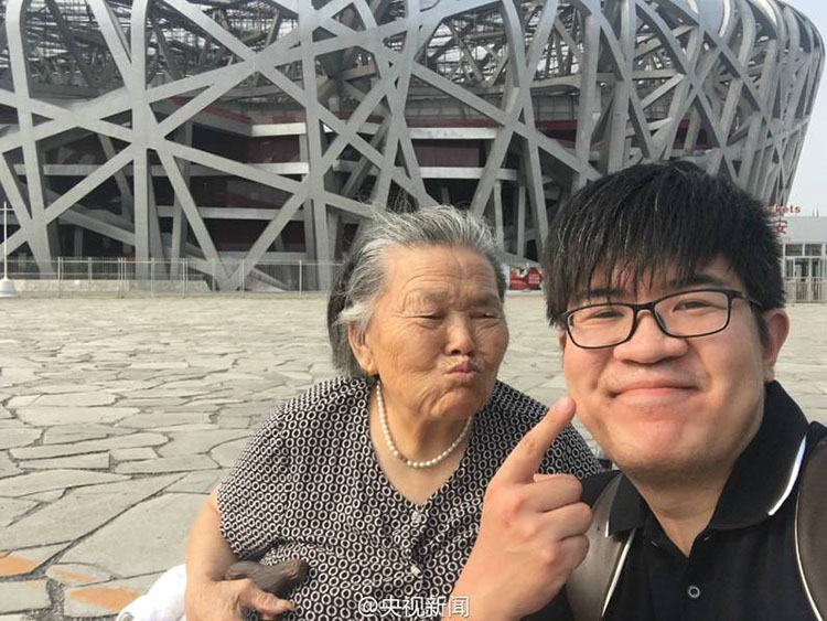 Young man accompanies wheelchair-bound grandmother to Beijing