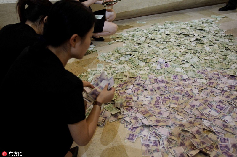 Elderly couple uses small bills to purchase property