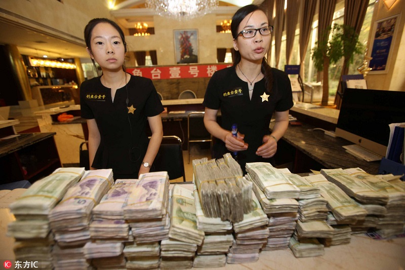 Elderly couple uses small bills to purchase property