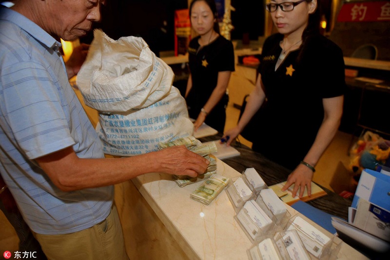 Elderly couple uses small bills to purchase property