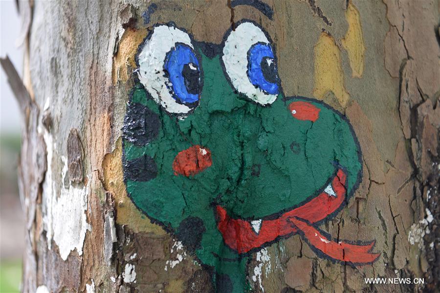 Fifteen art students of the university created 30 tree hollow paintings on campus to greet freshmen as new semester started.