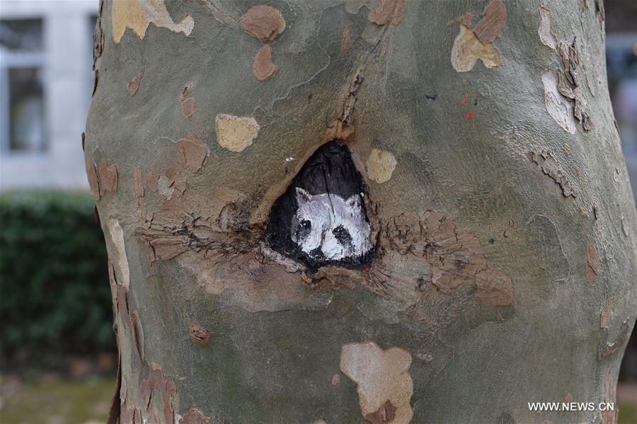 Fifteen art students of the university created 30 tree hollow paintings on campus to greet freshmen as new semester started.