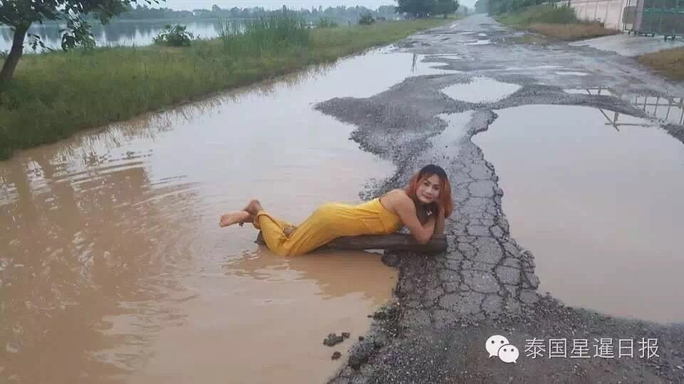 Thai woman takes bath in pothole to protest terrible road conditions