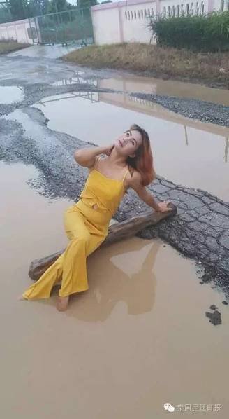 Thai woman takes bath in pothole to protest terrible road conditions