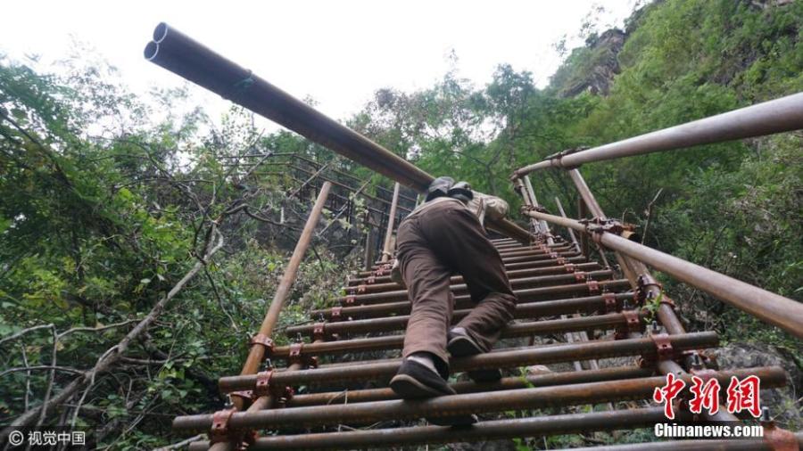 Village on cliff builds steel ladder to connect with valley 1km below