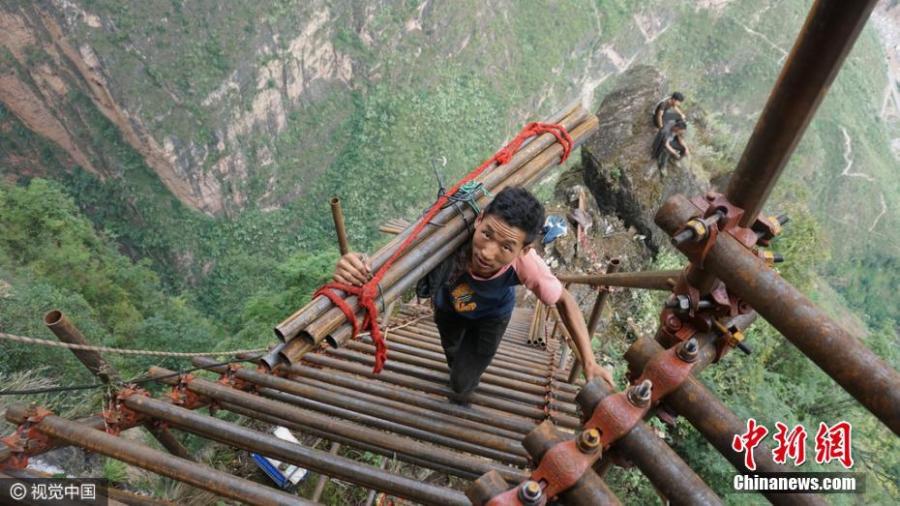 Village on cliff builds steel ladder to connect with valley 1km below
