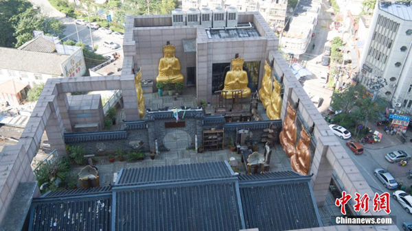 Gilded Buddha statues on building roof demolished
