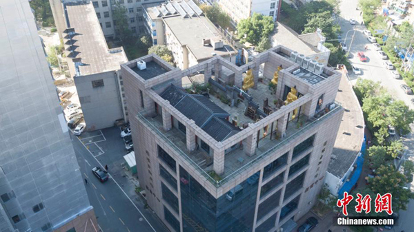 Gilded Buddha statues on building roof demolished