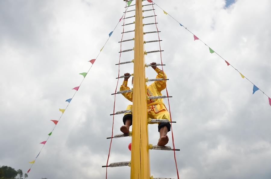 Stunt 'climbing on blades' performs in China's Fujian province