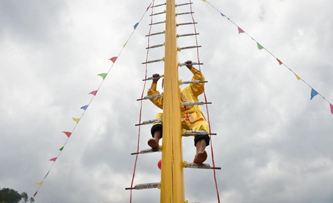 Stunt 'climbing on blades' performs in China's Fujian