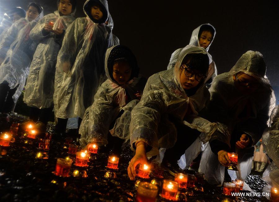 Photo taken on Dec. 13, 2016 shows the scene of a candlelight vigil for China's National Memorial Day for Nanjing Massacre Victims at the memorial hall for the massacre victims in Nanjing, east China's Jiangsu Province. (Xinhua/Sun Can)