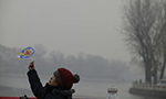 ‘Smog refugees’ flee Beijing air pollution, while those stuck behind choke in the city 