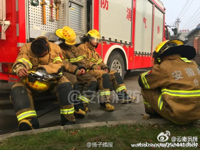 Exhausted firefighters are spotted sleeping in the streets of Hefei, Anhui province on Jan. 3, 2017.