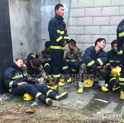 Exhausted firefighters spotted sleeping in street