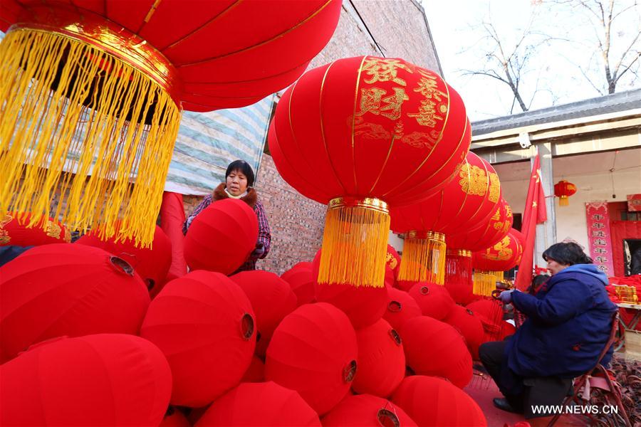 Villagers make red lanterns in Beileng Township of Wenxian County, central China's Henan Province, Jan. 12, 2017. Villagers need to keep up with the lantern orders to meet the Spring Festival market demand. The Spring Festival falls on Jan. 28 this year. (Xinhua/Xu Hongxing)