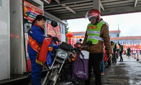 Migrant workers ride home on motorcycles 