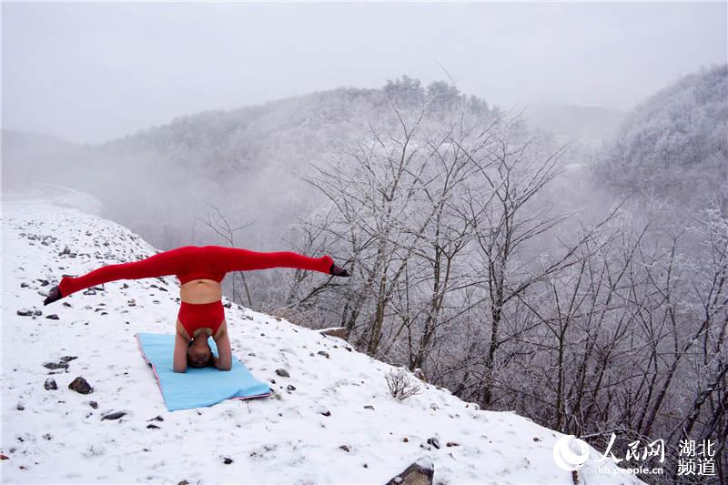 49-year-old yoga instructor practices yoga on icy alpine meadow