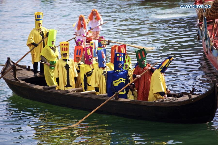 Rowers wearing costumes sail during the Water Parade event of the Venice Carnival in Venice, Italy, Feb. 12, 2017.