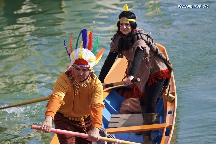 Rowers wearing costumes sail during the Water Parade event of the Venice Carnival in Venice, Italy, Feb. 12, 2017.