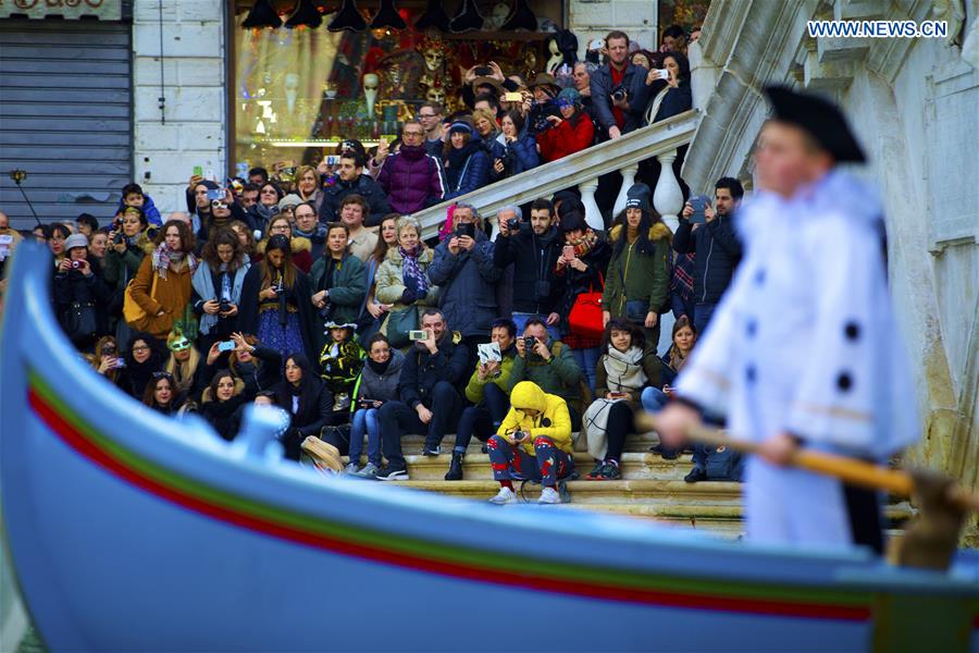 People watch the Water Parade event of the Venice Carnival in Venice, Italy, Feb. 12, 2017.