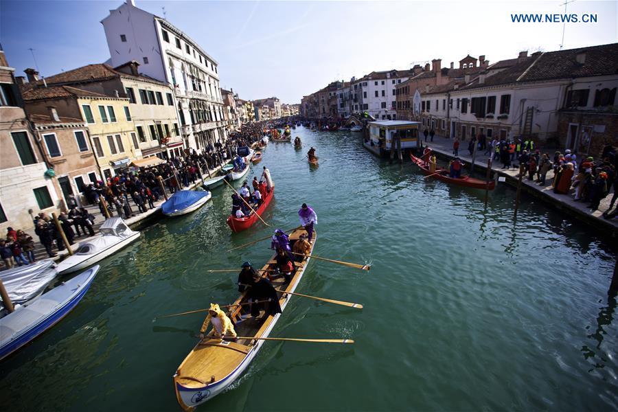 Rowers wearing costumes sail during the Water Parade event of the Venice Carnival in Venice, Italy, Feb. 12, 2017.