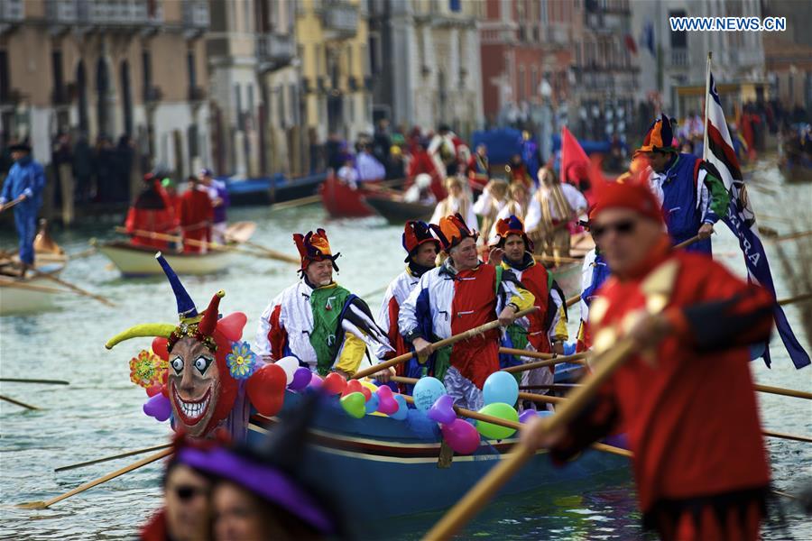 Rowers wearing costumes sail during the Water Parade event of the Venice Carnival in Venice, Italy, Feb. 12, 2017.