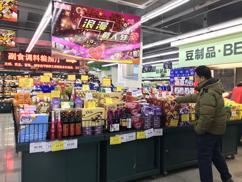A customer shops at a Valentine's-themed promotion section in a supermarket in Chaoyang district, Beijing on Tuesday. Photo: Huang Ge/GT
