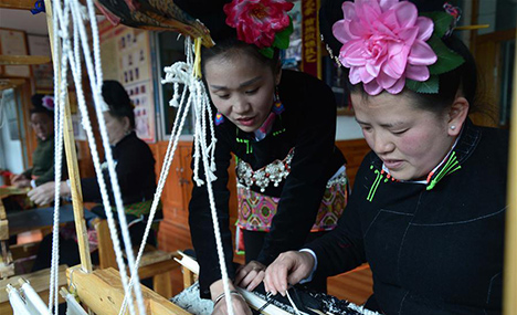 Women from Miao ethnic group learn brocade weaving