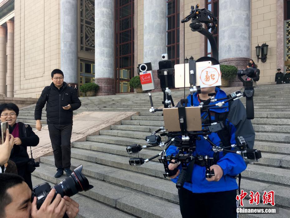 Journalist equipped with 'iron man' broadcast devices during Two Sessions